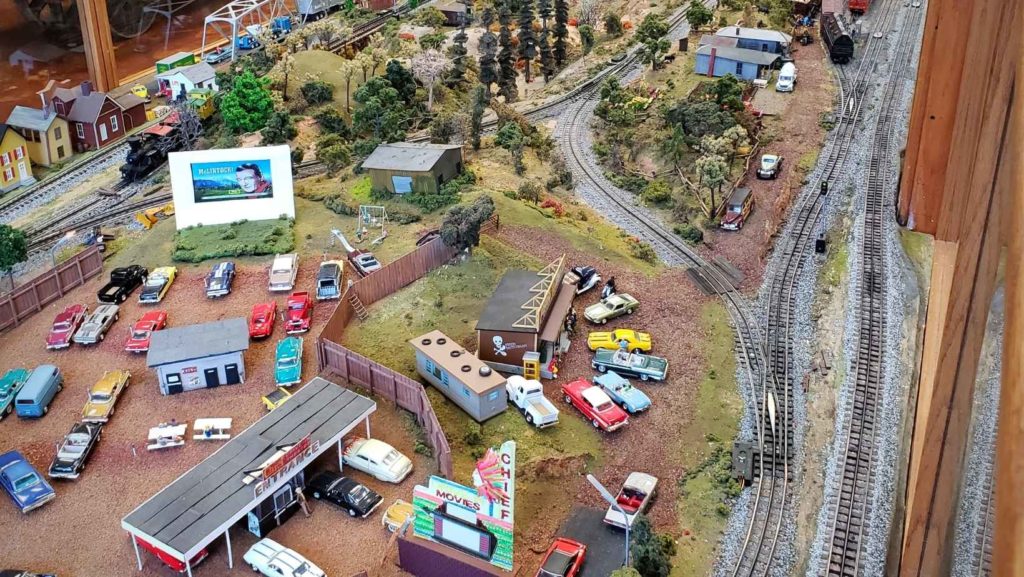 Miniature train tracks winds through a recreated town complete with a drive-in movie theatre.