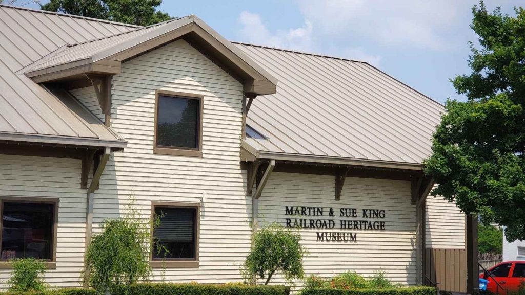 A beige building sits in front of a clear blue sky. The sign reads "Martin & Sue Railroad Heritage Museum."